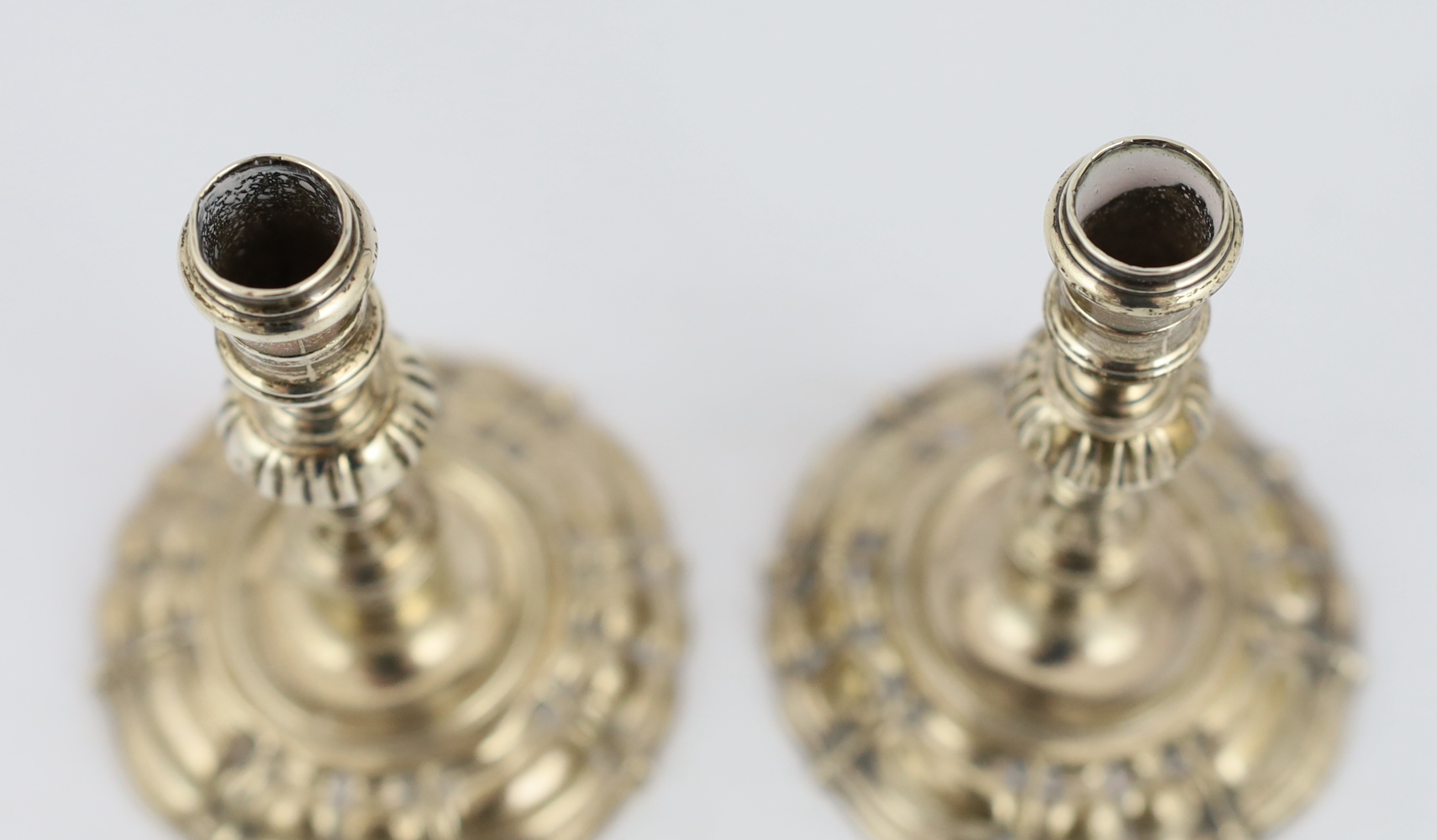 A pair of George II cast silver tapersticks, by James Gould